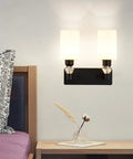 Dope Minimalist Black Wall Sconce With Rugged Iron Frame And Frosted Glass Shade providing chill ambient glow for bedside.
