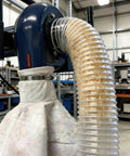 Heavy Duty 2.5 Inch By 10 Foot Clear PVC Dust Collection Hose With Carbon Steel Wire Coil attached to dust collector