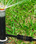 Tool-Free Press-In Outdoor Junction Box Kit With 3 Pin Connectors, IP68 Waterproof shown in garden use near sprinkler