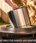 42 Inch Fire Pit Surround Tabletop Shield For Wood Burning Pits being set up on a patio, showcasing its adaptability for various setups.