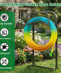 Outdoor Garden Hose Holder Stand 43 Inches Tall With Four Prongs Base Detachable Metal Hose Keeper in a garden scene