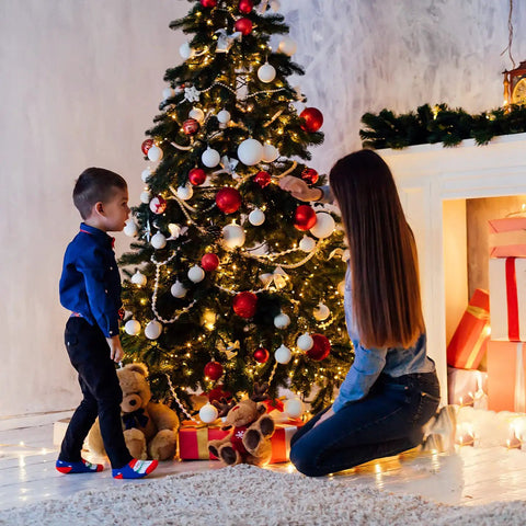Child and adult decorating Christmas tree with 42.6 Foot Battery Powered Fairy Lights With 120 LEDs IP65 Waterproof Twinkle String