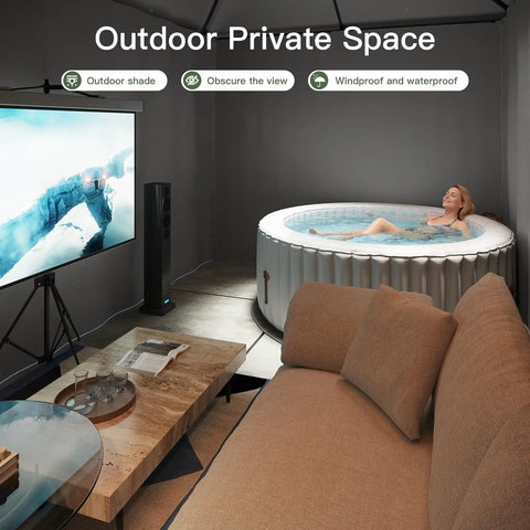 Relaxing in an inflatable hot tub in a cozy, covered outdoor area with a reclining sofa, screen, and round coffee table.