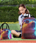 Child sitting on grass with colorful neon bear design backpack and lunch bag, both featuring sunglasses-wearing bear print.