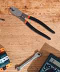 Dang Tough Lightweight Wire Strippers And Cutting Pliers Featuring Slick Ergonomic Rubber Grips and Rock Solid Steel Build for Seasoned Trade Electricians and Contractors on a wooden workbench.