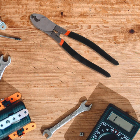 Dang Tough Lightweight Wire Strippers And Cutting Pliers Featuring Slick Ergonomic Rubber Grips and Rock Solid Steel Build for Seasoned Trade Electricians and Contractors on a wooden workbench.