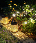 Two Pack Solar Watering Can Garden Lights illuminating a garden with cascading glow, hanging waterproof lanterns for outdoor decor.