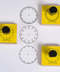 Totally Sweet Wooden Analog Clock Stamp Set For Kids Learning To Tell Time With Teachers And Parents Super Handy For Craft Projects and Classroom Fun No Hands Design Makes Teaching A Breeze, featuring three wooden clock stamps and printed clock faces.