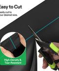 Close-up of cutting Heavy Duty Pro Grade Weed Barrier Landscape Fabric 5 Oz Dual Layer Ground Cover Mat with scissors.