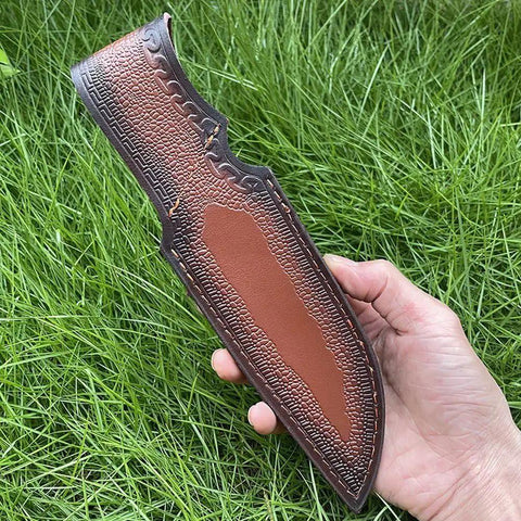 Rugged Leather Knife Sheath For Fixed Blade Knives With Secure Buckle Scabbard Pouch held outdoors on grass