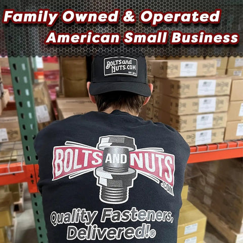 Person wearing 'Bolts and Nuts' shirt and cap in a warehouse, promoting family-owned American small business.