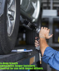 Mechanic using Half Inch Drive Impact Socket 34mm Deep 6 Point For Axle Nut Removal on car wheel in garage