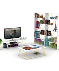 Modern living room with white bookcase, decor items, TV stand, and coffee table in geometric design.