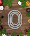 Three Piece Lace Oval Metal Die Cuts Set With Stitched Nesting Tag Frames for Scrapbooking displayed on decorative wooden background.