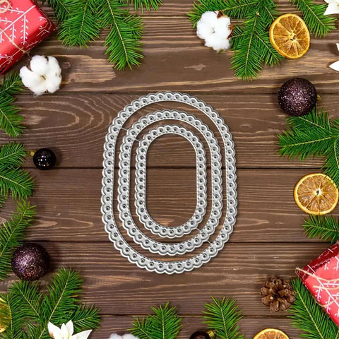 Three Piece Lace Oval Metal Die Cuts Set With Stitched Nesting Tag Frames for Scrapbooking displayed on decorative wooden background.