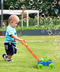 Toddler playing with Bubble Lawn Mower Toy With Realistic Sounds And Bubble Maker For Toddlers in grassy garden
