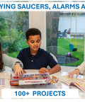 Children using Electronics Exploration Kit with 100 Plus Projects and Full Color Project Manual, 28 Part Set at a table.