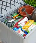 Heavy Duty Resin Outdoor Storage Deck Box 74 Gallon Weatherproof Gray for Patio Yard Pool Toys Tools Cushions and More filled with gardening tools