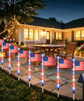 Patriotic Solar Pathway Lights Eight Pack With Red White Blue LEDs illuminating garden patio at night