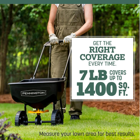 Person using spreader on lawn to apply Premium Kentucky 31 Tall Fescue Grass Seed To Build A Badass Drought Resistant Lawn That Powers Through Heavy Foot Traffic And Thrives In Full Sun To Medium Shade For Quick Germination Inside A 7 Lb Bag.