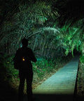 Person using Dope 700 Lumen USB C Rechargeable EDC Flashlight With Dual Power and Multifunctional Sidelight on forest path