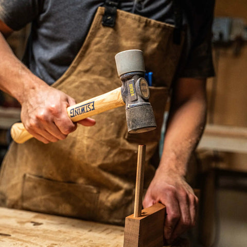 Man using 12 Oz Double Face Rubber Mallet With Soft And Hard Tips And Hickory Handle Built With Triple Wedge Construction for carpentry