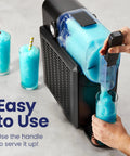 Straight Up Slushie Machine With Zero Ice Required, 48 Oz Frozen Drink Maker pouring slushie into a glass with vibrant blue drink.