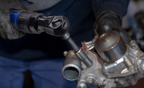 Hella Tough Pneumatic Shop Beast Featuring One Half Inch Five Speed Impact Wrench And Three Eighth Inch Ratchet with a mechanic using the ratchet on an engine part.