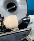 Carbide Tipped Wood Lathe Live Center 2MT Morse Taper Shank installed on a wood lathe, turning a wooden piece at high speed