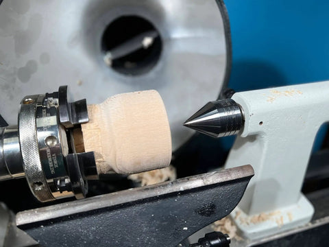 Carbide Tipped Wood Lathe Live Center 2MT Morse Taper Shank installed on a wood lathe, turning a wooden piece at high speed