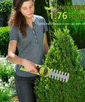 Person using 12V Cordless 2 In 1 Hedge Trimmer And Grass Shears For Quick No Fuss Pruning Lightweight Handheld Electric Shrub Tool on bush