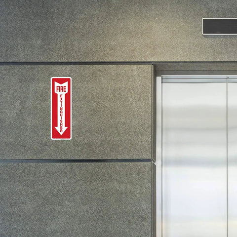 Fire Extinguisher Decal Self Adhesive Sticker 4x12 Inches 4 Mil Vinyl Sign For Indoor And Outdoor Use UV Protected And Waterproof Sleek Yet Tough As Nails Label Pack Of 3 installed on a gray wall near an elevator.