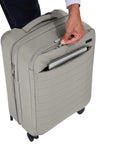 Person placing laptop in Softside Bigger Carry On Luggage 23 Inch Expandable With Spinner Wheels Built Tough Nylon Cloud Gray