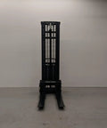 Heavy Duty Thin Leg Semi Electric Pallet Stacker 2204 Lbs Capacity 138 Inch Lift Height 110V Plug seen from the front with forks down.
