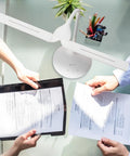 Dual Shade LED Desk Lamp With Three Color Temperature Modes, Auto Shutoff Timer, Adjustable Neck And Touch Activated Controls lighting papers on shared desk.