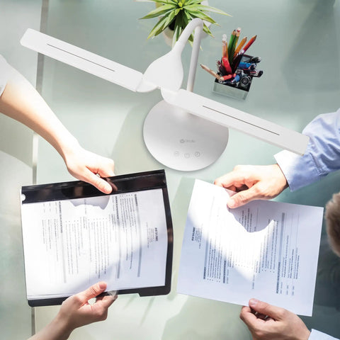 Dual Shade LED Desk Lamp With Three Color Temperature Modes, Auto Shutoff Timer, Adjustable Neck And Touch Activated Controls lighting papers on shared desk.