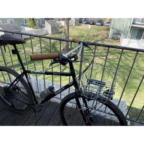 Klunker Upright Bicycle Handlebar for Commuter and Urban Riding, attached to bike with basket on balcony, Nickel Silver Chromoly