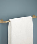 24 Inch Towel Bar Champagne Bronze Finish Space Saving Wall Mounted Bath Accessory with white towel on dark wall