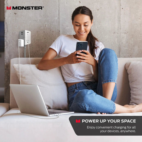 Power Shield XL Surge Protector with Outlet Extender in modern home office, powering laptop and phone from wall plug