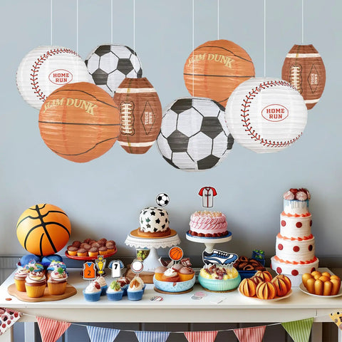 8 Pack 12 Inch Sports Paper Lanterns Set for Party Decor Includes Soccer Ball Basketball Baseball American Football and Japanese Hanging Lanterns Reusable Game Day Birthday Favors for Kids hanging over a dessert table.