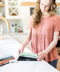 Woman using Pro Grade Knife Sharpening Kit With Whetstone Bowl, 15-Piece Set, Dual Grit stones in kitchen setting