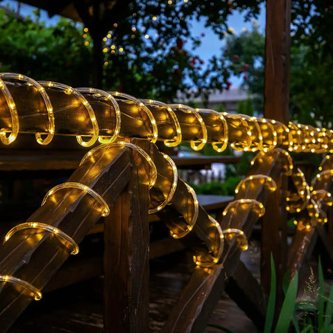 66 Feet Of 200 LED Solar Rope Lights With 8 Modes No Fuss Waterproof Outdoor String Lights In Clear Tube For Garden Patio Deck Backyard Porch Pool Tree Decor Warm White Auto On Off on wooden railing at night