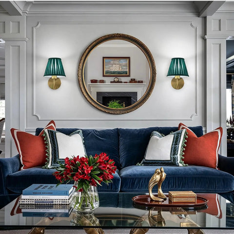 EIDISUNY Battery Operated Wall Sconces beside a round mirror, with rattan shades and gold accents in a living room setting.