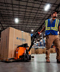 Premium Global Industrial Self-Propelled Electric Pallet Jack Truck Featuring Dual 60Ah Batteries in a warehouse handling a box.