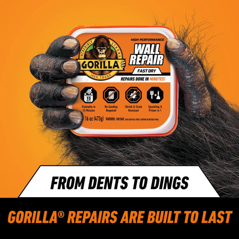 Heavy Duty Wall Repair Spackling Plus Primer 16 Oz White Tub Patch Cracks Holes And Uneven Ceilings With Smooth Finish Easy To Spread No Sag Or Cracking Durable Repair For Walls held by gorilla hand on orange background