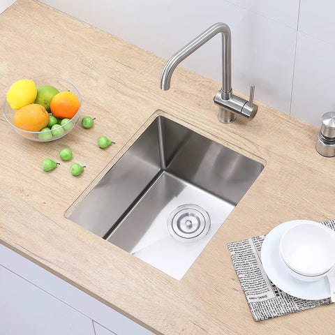 Top view of Undermount Bar Sink For Kitchen And RV Outdoor Use 15 By 17 Inch Single Bowl Brushed Nickel 18 Gauge Stainless Steel T 304 Stain And Corrosion Resistant Heavy Duty Prep Sink With Strainer installed on wooden countertop with faucet.