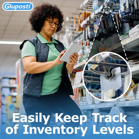 Store employee checks stock using tablet with Black Squeeze And Pinch Pegboard Clips securing hooks on slat walls.