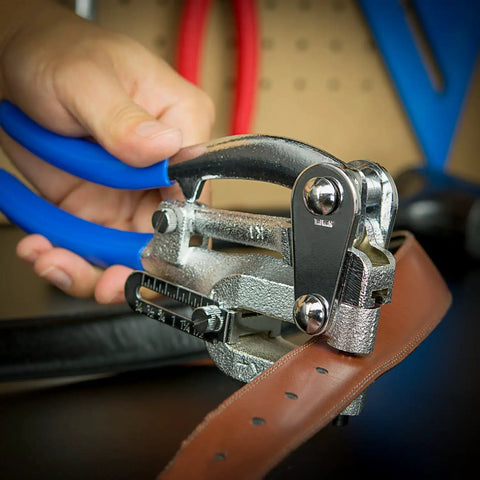 Using Handheld Power Punch Kit for precise holes in sheet metal with chrome vanadium punches, showing application on leather strap.