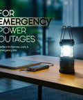 LED Camping Lantern For Outdoor Adventures And Home Power Outages on a wooden table, illuminated, next to a closed laptop.