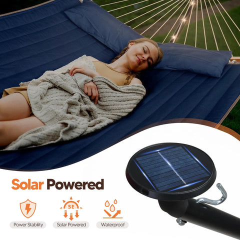 Double Outdoor Hammock With Twelve Foot Stand And Solar Powered Lights Portable Two Person Hammock With Stand In Dark Blue For Backyard Patio Camping And Relaxation showing a person lying peacefully with integrated solar lights.